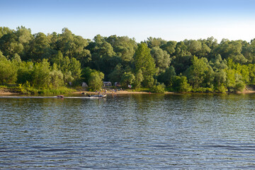July 4, 2020: People with tents resting on the banks of the river. The Volga River. Russia.