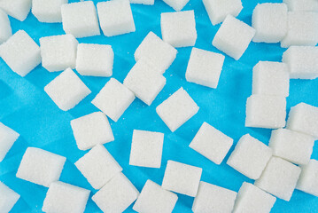sugar cubes on a blue background. diabetes concept background.