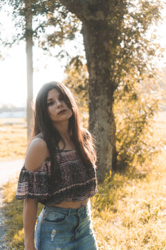 Beautiful Asian Girl Wearing A Crop Top And A Jean Skirt Looking At The Camera At The Park