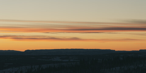 View from Totenåsen Hills toward the mountains in the west of Norway at winter in evening.
