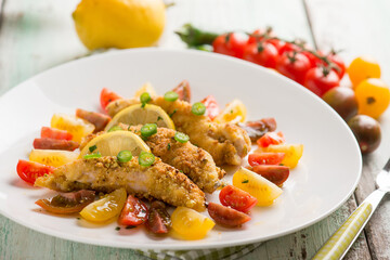 breaded chicken fillet with tomato salad