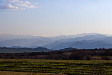 Mountain range landscape during sunset, view of mountain and peak lines, horizon