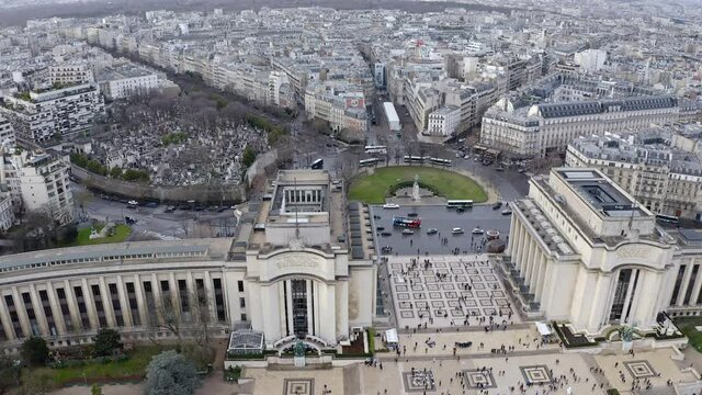 Cinematic aerial view of Gardens of the Trocadero museum around Paris streets in France feat. business district skyscrapers in the city skyline in HD and 4K resolution 