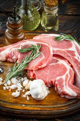 Raw meat with spices in a composition with kitchen accessories.