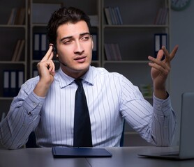 Call center operator talking to customer during night shift