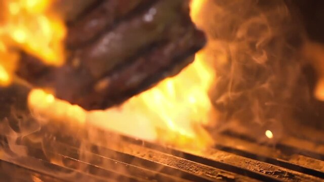 Close-up of a grilled steak. During the overturning, a fire appears