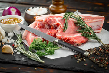 Raw meat with spices in a composition with kitchen accessories.