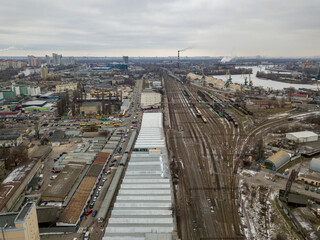 Freight trains at the station. Aerial drone view. Winter cloudy morning.