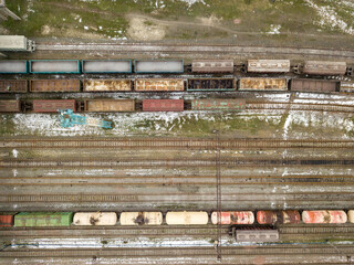 Freight trains at the station. Aerial drone view. Winter cloudy morning.