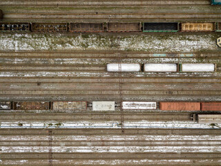 Freight trains at the station. Aerial drone view. Winter cloudy morning.