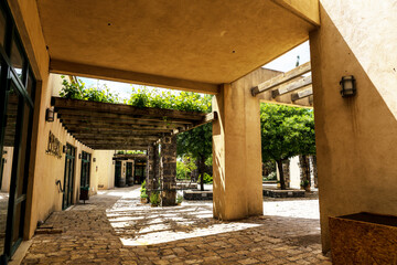 Typical example of Middle Eastern architecture with sun canopies and vine-covered wooden pergolas