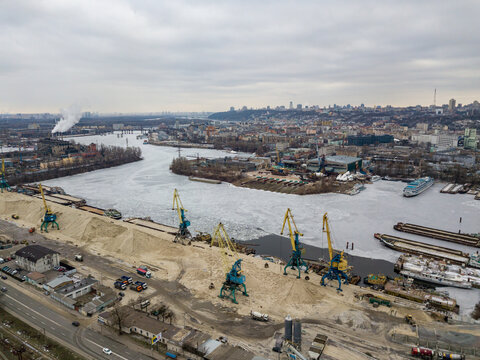 Frozen cargo port bay. Aerial drone view. Winter cloudy morning. - Powered by Adobe