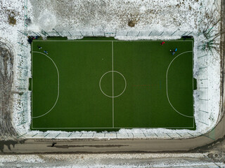 Football at the stadium. Aerial drone view. Winter snowy morning.