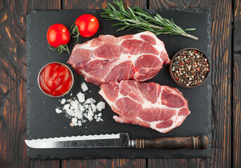 Raw meat with spices in a composition with kitchen accessories.