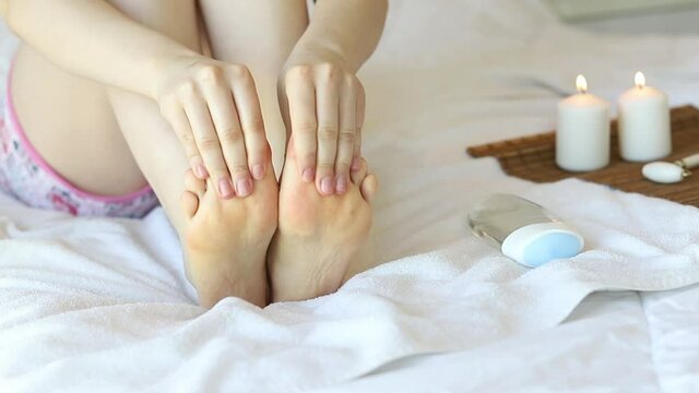 Woman doing self massage, foot