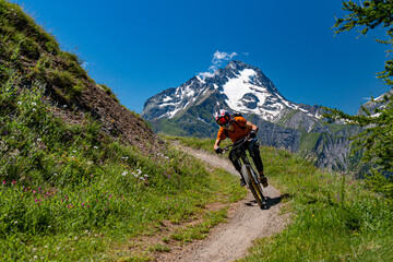 Rider mountain biking turn on downhill track, les 2 alpes, ecrins, oisans, france