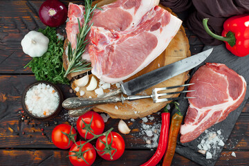 Raw meat with spices in a composition with kitchen accessories.