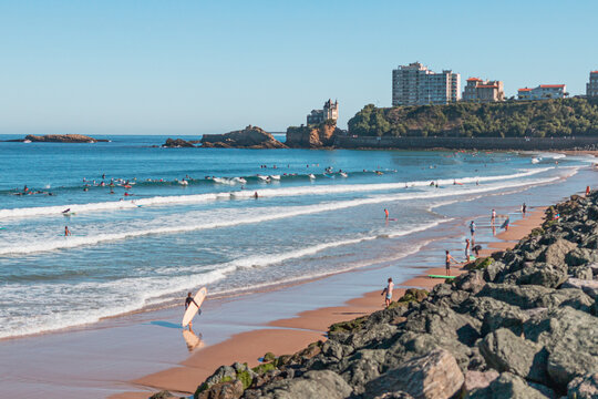 Surfer walking on the cote des basques beach in summer, Biarritz, Pays Basque, France
