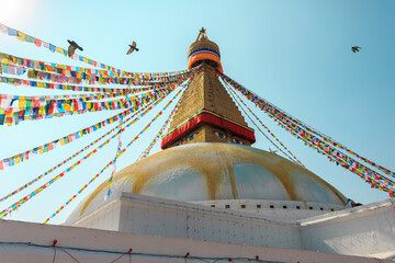 Multicolor prayer buddhist flags fluttering in the wind on the Boudhanath stupa in Kathmandu, Nepal.