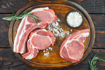 Raw meat with spices in a composition with kitchen accessories.