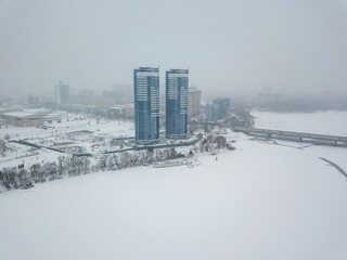 The left bank of Kiev in a blizzard. Aerial drone view. Winter snowy morning.