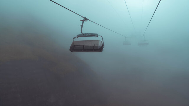 Creepy cable car in dark fog