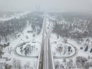 Kiev metro line in a snowy park. Aerial drone view. Winter snowy morning.