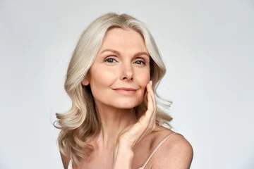 Foto op Canvas Beautiful gorgeous 50s mid aged mature woman looking at camera isolated on white. Mature old lady close up portrait. Healthy face skin care beauty, middle age skincare cosmetics, cosmetology concept © insta_photos