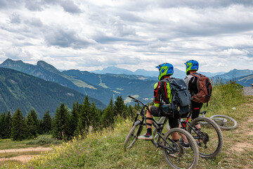mountain bike riders looking at the landscape in summer, France