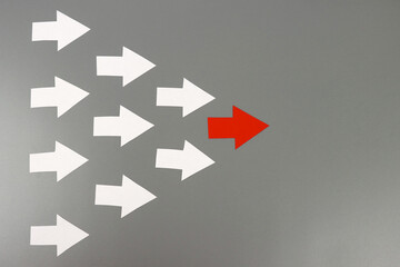 Red arrow leads many white arrows, a leadership concept