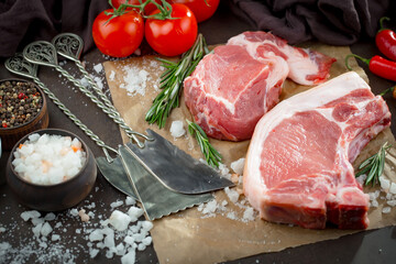 Raw meat with spices in a composition with kitchen accessories.
