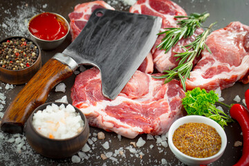 Raw meat with spices in a composition with kitchen accessories.