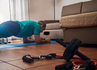 Ordinary man playing sports at home, trying to improve fitness.