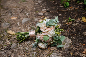 the bride's beckett with wedding rings lies on the road