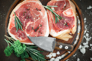Raw meat with spices in a composition with kitchen accessories.