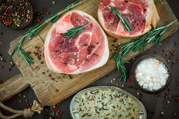 Raw meat with spices in a composition with kitchen accessories.
