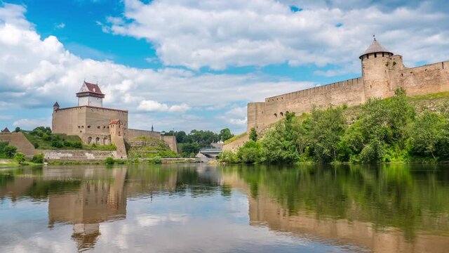 Timelapse of beautiful city scenery, historic landmarks on Russian Estonian border, Narva Herman castle and Ivangorod fortress on banks of Narva river, cloudy sky skyline