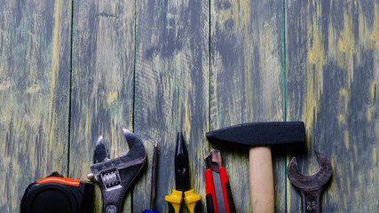 tools top view on a coloured wooden background