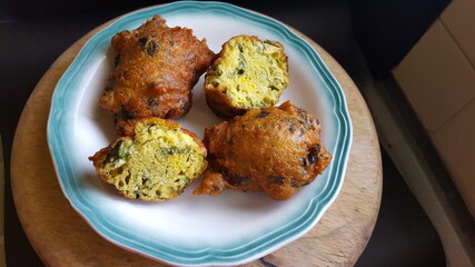 A plate of Trinidad and Tobago's  Saheena (Sahina), one is cut to show the inside of this Traditional Street Food. 