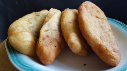 A close-up shot of some Trinidad and Tobago's Street Food called fried flour pies, Aloo-pies or potato pies. 