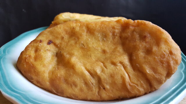 A close-up shot of a Trinidad and Tobago's Street Food called fried flour pies, Aloo-pies or potato pies. 
