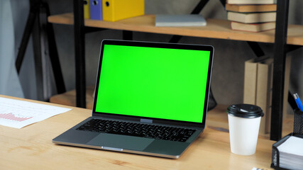Close up modern laptop computer display mock up chroma key green screen standing on table working...