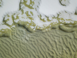 Obraz premium Snowy textures on the freezing river. Aerial drone view. Winter snowy morning.