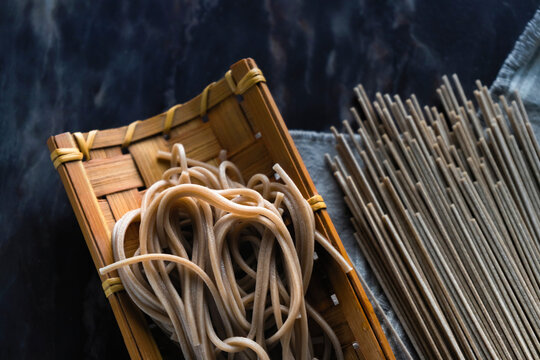 Close-up of buckwheat noodles in bamboo wicker tray on table