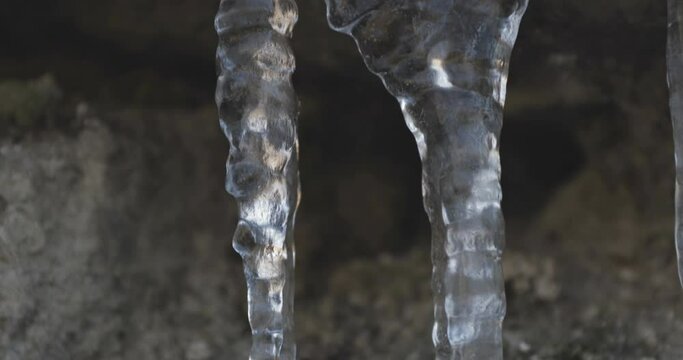 Icicles hanging off of a rock, winter landscape at lessinia park