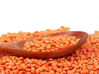 Red lentil in spoon isolated on the white background