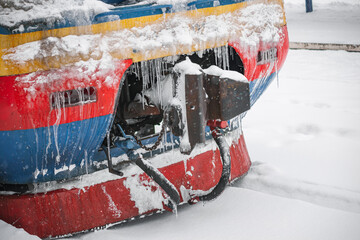 LVIV, UKRAINE - FEBRUARY 10, 2021 :The train is waiting for departure at the station, around a lot of snow, Lviv Suburban railway station.