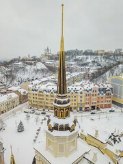 Spire on a building in Kiev. Aerial drone view. Winter snowy morning.