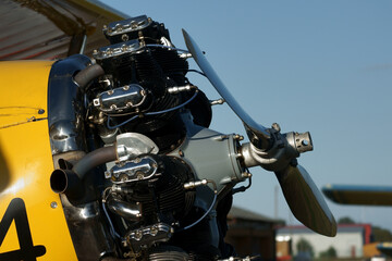 restored old yellow biplane with one engine per propeller