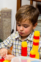 portrait of child playing with construction set